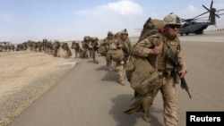 U.S. Marines prepare to depart at the end of operations for Marines and British combat troops in Helmand, Afghanistan, Oct. 27, 2014. 