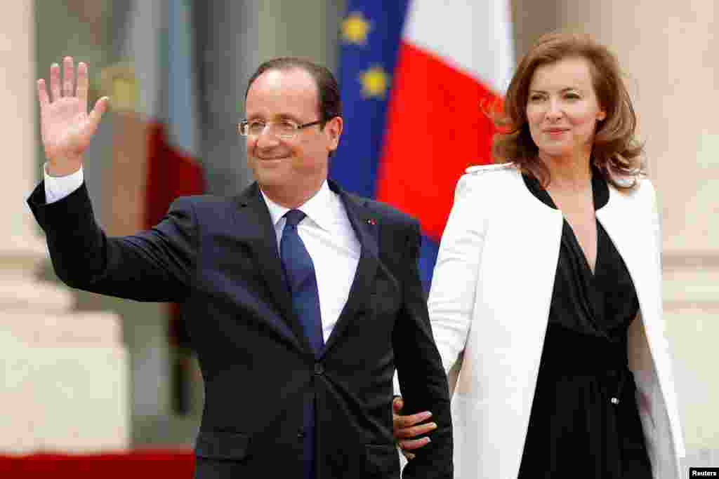 Hollande and his companion Valerie Trierweiler leave the Elysee Palace after the handover ceremony.