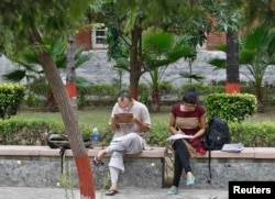 FILE - Indian students study inside the Delhi University campus in New Delhi.