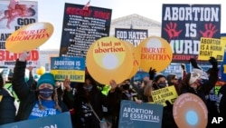 Protesters for and against abortion rights demonstrate in front of the U.S. Supreme Court, Dec. 1, 2021, in Washington.