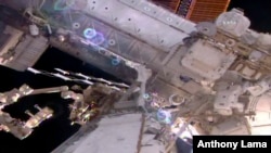 This still image taken from live video provided by NASA shows astronaut Shane Kimbrough, right, works on the International Space Station during a space walk March 24, 2017. 