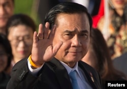 FILE - Thailand's Prime Minister Prayuth Chan-ocha waves as he arrives for a group photo of leaders at the 11th Asia-Europe Meeting (ASEM) in Ulaanbaatar, Mongolia.