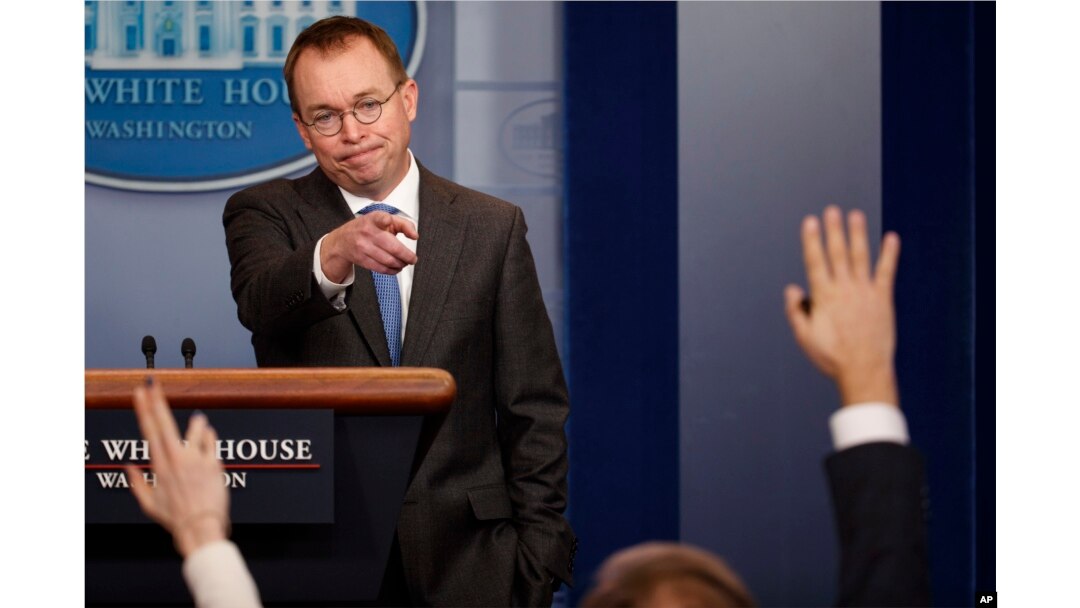 Director of the Office of Management and Budget Mick Mulvaney calls on a reporter during a White House briefing about a possible government shutdown, Jan. 19, 2018, in Washington.