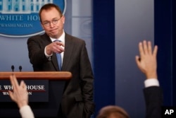 FILE - Director of the Office of Management and Budget Mick Mulvaney calls on a reporter during a White House briefing , Jan. 19, 2018, in Washington.