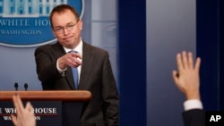 FILE - Director of the Office of Management and Budget Mick Mulvaney calls on a reporter during a White House briefing, Jan. 19, 2018, in Washington.