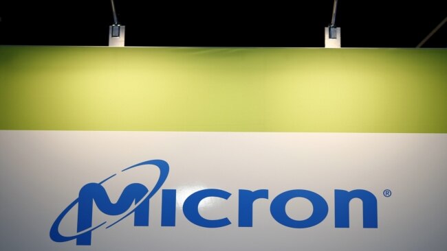 FILE - The logo of U.S. memory chip maker Micron Technology is pictured at its booth at an industrial fair in Frankfurt, Germany, July 14, 2015.