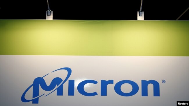 FILE - The logo of U.S. memory chip maker Micron Technology is pictured at its booth at an industrial fair in Frankfurt, Germany, July 14, 2015.