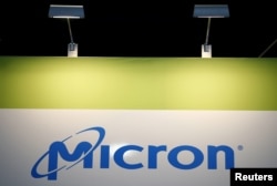 FILE - The logo of U.S. memory chip maker Micron Technology is pictured at its booth at an industrial fair in Frankfurt, Germany, July 14, 2015.