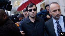 Martin Shkreli, center, leaves the courthouse after his arraignment in New York, Thursday, Dec. 17, 2015. 