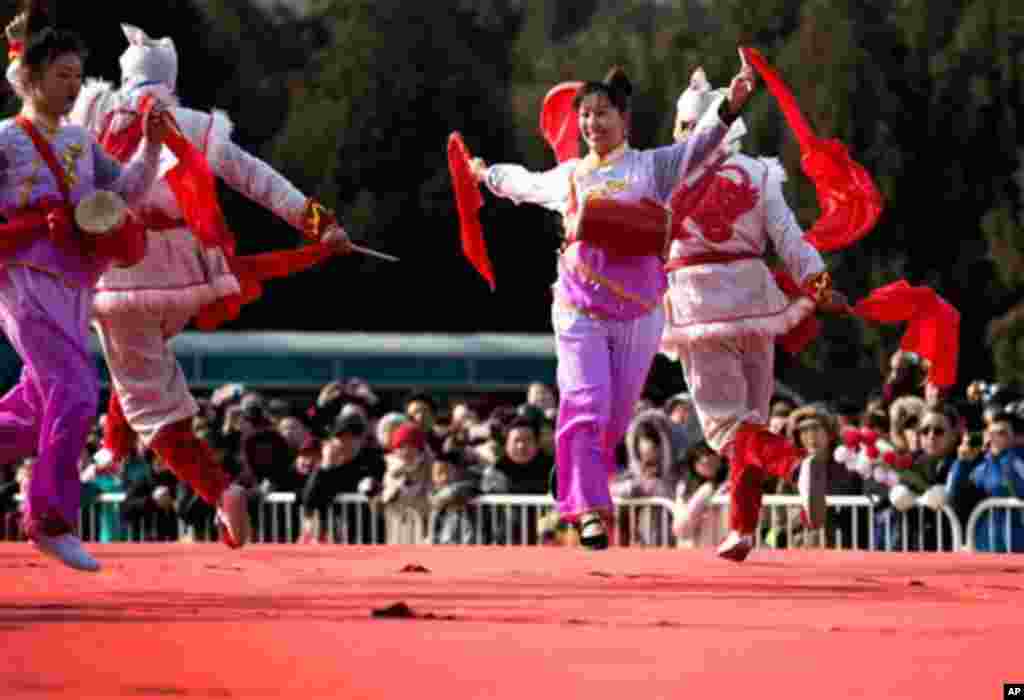 Artists perform a traditional dance on stage at the Ditan temple fair on the first day of Lunar New Year in Beijing Sunday, Feb. 10, 2013. Millions across China are celebrating the arrival of the Lunar New Year, the Year of the Snake, marked with a week-long Spring Festival holiday. 