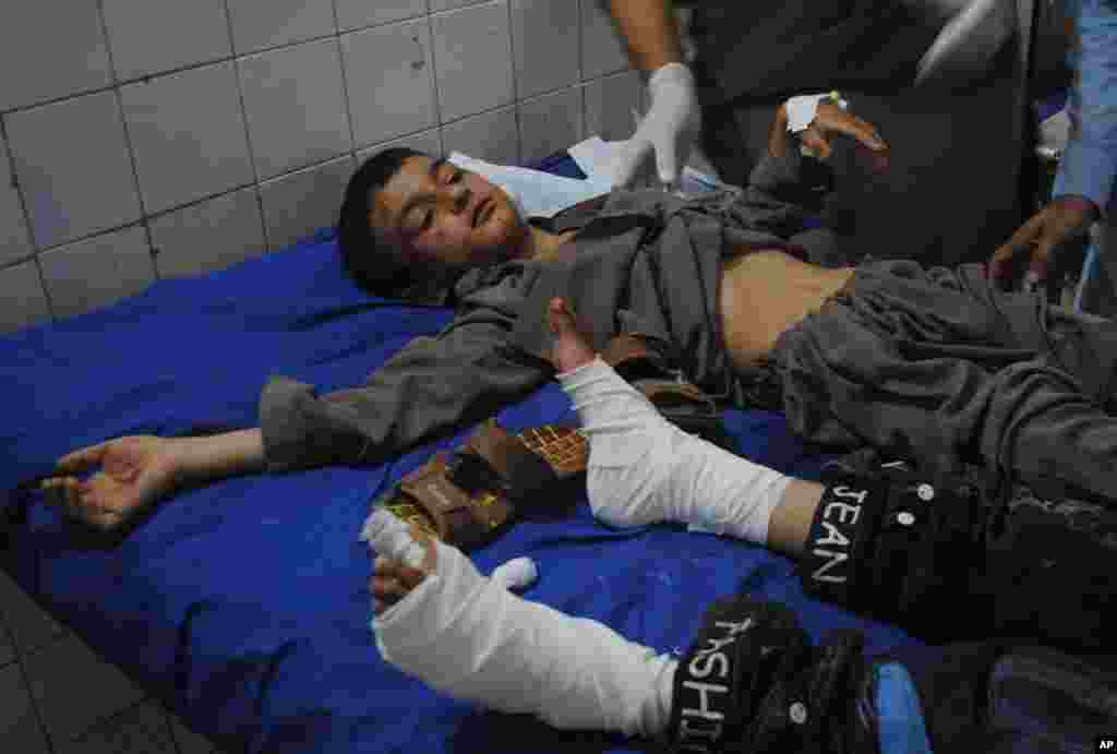 Boys injured in a suicide bombing are treated at a hospital in Peshawar, Pakistan, June 21, 2013.