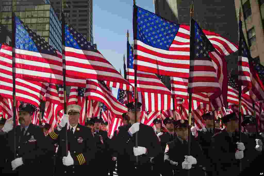 Firefighters march up Fifth Avenue during the St. Patrick&#39;s Day Parade in New York City. St. Patrick&rsquo;s Cathedral displayed both the American and Irish flags and a special Mass was held there before the parade stepped off.