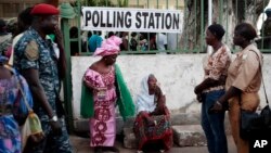 Gambians wait to cast their vote at a polling station in Banjul, Gambia, Dec. 1, 2016. 