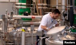 FILE - A Novo Nordisk employee controls a machine at an insulin production line in a plant in Kalundborg, Denmark, Nov. 4, 2013.