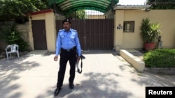 FILE: A policeman stands guard outside the Save the Children charity's office in Islamabad, Pakistan, June 12, 2015. 