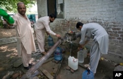 People collect water at a tube well in Islamabad, Pakistan, Aug. 23, 2017. A new study suggests about 50 million Pakistanis could be at risk of drinking arsenic-tainted groundwater.