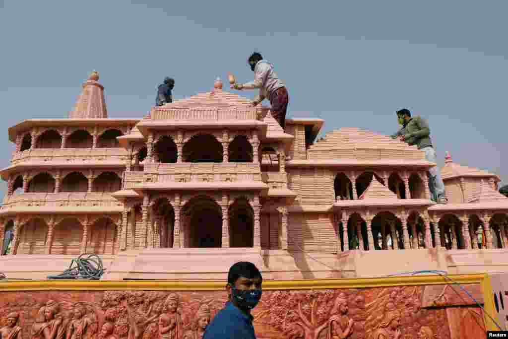 Workers give finishing touches to the model of the proposed Ram temple that Hindu groups want to build at a religious site in Ayodhya, in New Delhi, India.