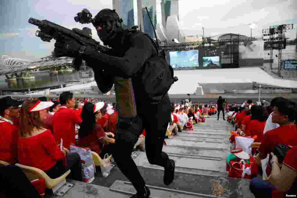 A navy diver enters into the gallery during a military display at Singapore&#39;s 52nd National Day celebrations at Marina Bay in Singapore.