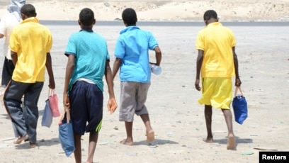 Ethiopian migrants walk after arriving to Yemen's shore on a smugglers boat in the southern province of Shabwa, Yemen, Aug. 11, 2017.