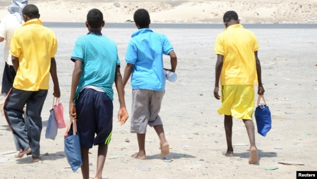 Ethiopian migrants walk after arriving to Yemen's shore on a smugglers boat in the southern province of Shabwa, Yemen, Aug. 11, 2017.