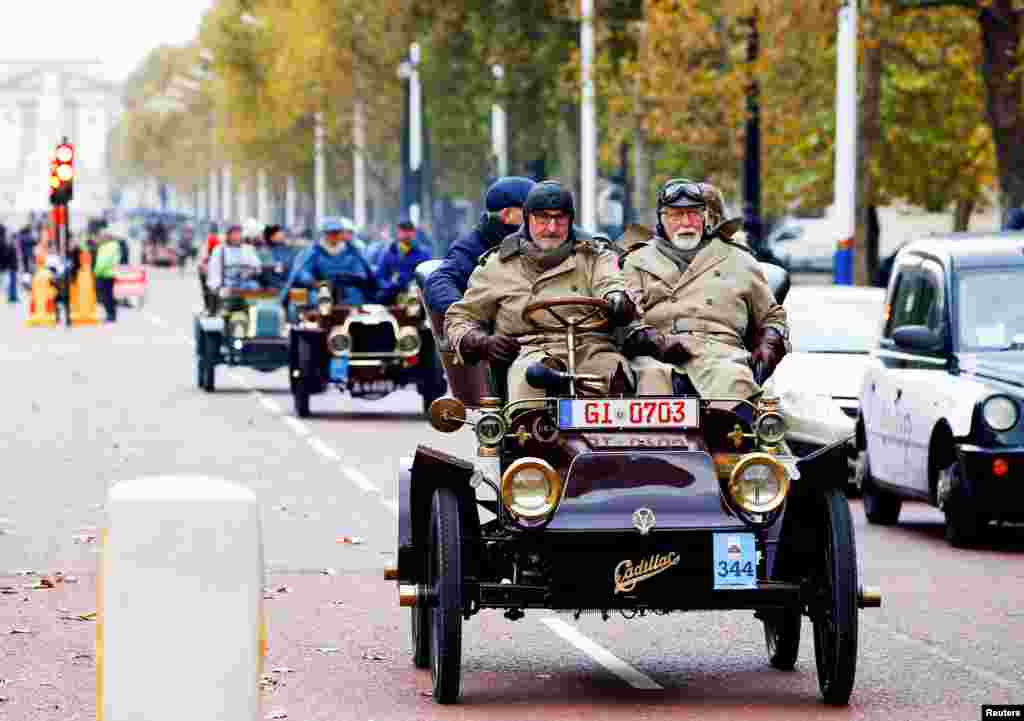 Participants in the London to Brighton Veteran Car Run make their way down The Mall, in London, Britain.