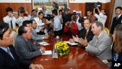 U.S. Deputy Assistant Secretary of State for Democracy, Human Rights, and Labor Scott Busby, second from right, talks with Cambodian Foreign Minister Hor Namhong, second from left, during a meeting inside, in Phnom Penh, Cambodia, Tuesday, June 2, 2015. S