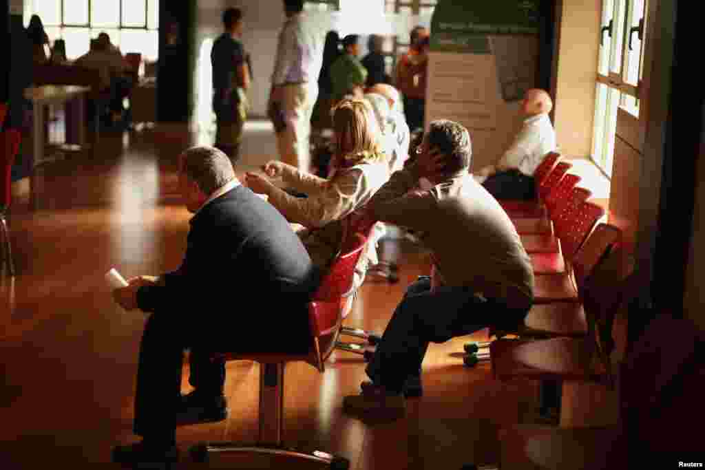 People wait inside a government-run employment office in Campillos, near Malaga, southern Spain. Spain&#39;s number of registered jobless fell by 46,050, or 0.91 percent, in April compared with the month before, leaving the number of unemployed to 4.98 million.