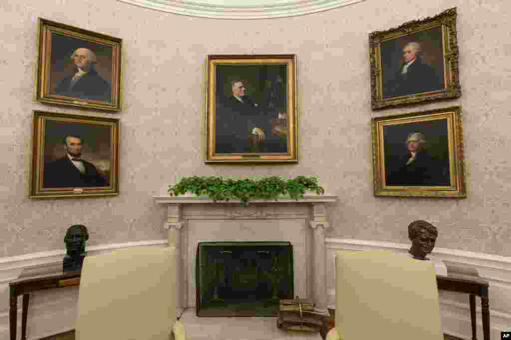 The Oval Office of the White House is newly redecorated for the first day of President Joe Biden&#39;s administration, Jan. 20, 2021, in Washington, including a pairing of former President Franklin D. Roosevelt over the mantle of the fireplace.