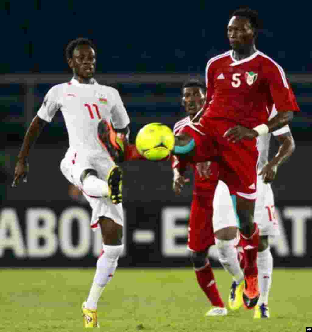 Jonathan Pitroipa of Burkina Faso (R) fights for the ball with Ala'a Eldin Yousif of Sudan during their African Nations Cup Group B soccer match at Estadio de Bata "Bata Stadium", in Bata January 30, 2012.