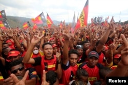 FILE - Supporters of the Revolutionary Front for an Independent East Timor (FRETILIN) political party shout during a rally on the last day of campaigning ahead of this weekend's parliamentary elections in Dili, East Timor, July 19, 2017.