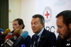 FILE - Peter Maurer, president of the International Committee of the Red Cross, center, speaks to journalists during a press conference in Sanaa, Yemen, Sunday, Aug. 9, 2015.