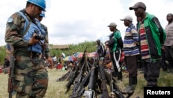 FILE - United Nations peace keepers record details of weapons recovered from the Democratic Forces for the Liberation of Rwanda (FDLR) militants after their surrender in Kateku,in Democratic Republic of Congo, May 2014.