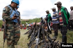 FILE - United Nations peacekeepers record details of weapons recovered from the Democratic Forces for the Liberation of Rwanda (FDLR) militants after their surrender in Kateku, a small town in eastern region of the Democratic Republic of Congo (DRC), May 30, 2014.