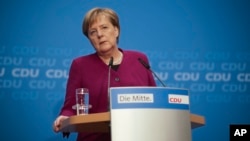 German Chancellor Angela Merkel addresses a news conference after a party's leaders meeting at the headquarters in Berlin, Germany, Monday, Oct. 29, 2018. (AP Photo/Markus Schreiber)