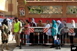 FILE - Egyptians wait to cast their votes outside a polling station during the Egyptian parliamentary election in Alexandria, Egypt, Oct. 18, 2015.