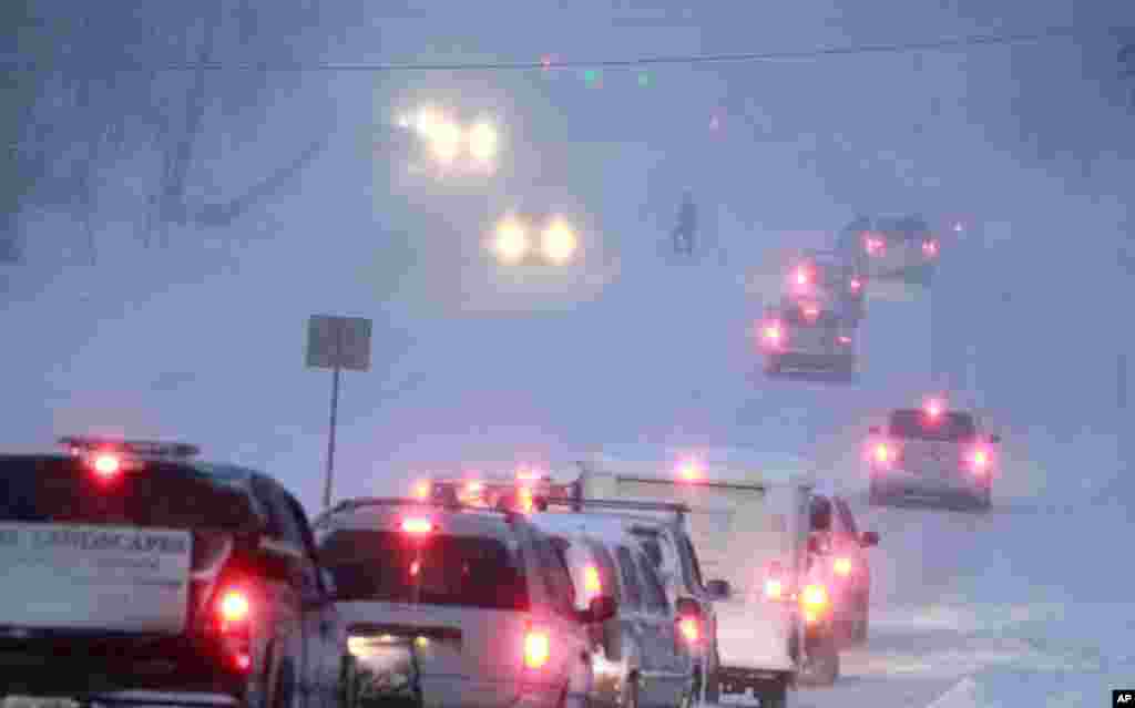 Cars are backed up as a van was stuck trying to get up a hill, Feb. 13, 2014 in Concord, New Hampshire.