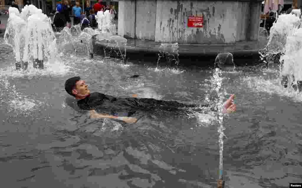 An England fan celebrates his team&#39;s win in a fountain in Lille during the Football Soccer EURO 2016 in Lens, France.