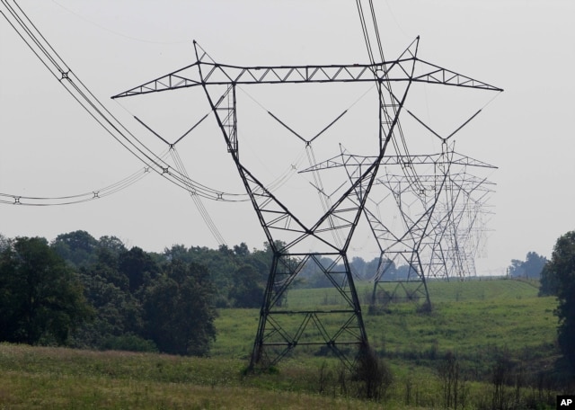 FILE - Electric lines extend over the hills of Owen County, near Owenton, Kentucky, July 22, 2011.