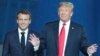 FILE — French President Emmanuel Macron, left, walks with former U.S. President Donald Trump at NATO headquarters in Brussels, July 11, 2018. During a town hall meeting last week, Trump refused to commit to U.S. membership of NATO if elected to a second term.