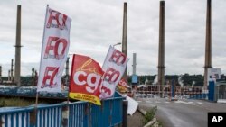 CGT and FO union flag flutter at the main entrance of the Feyzin refinery in background, near Lyon, central France, May 30, 2016. 