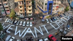 FILE - A slogan is written on a street as a protest after the coup in Yangon, Myanmar February 21, 2021. Picture taken with iPhone panoramic mode. REUTERS/Stringer/File Photo