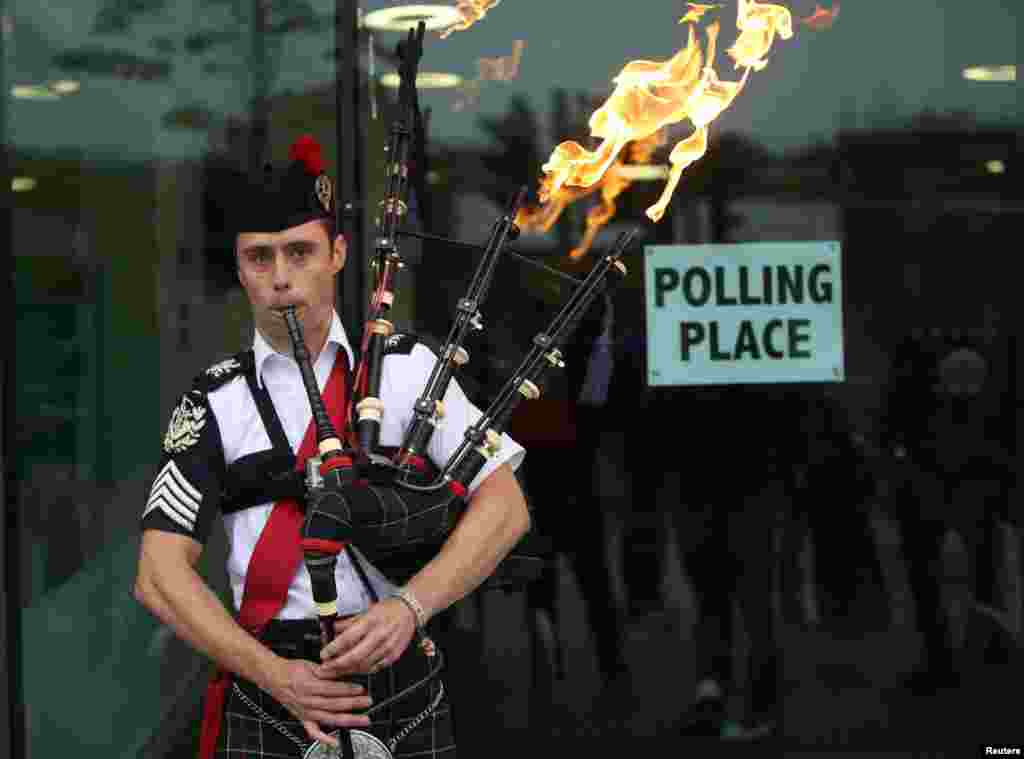 Ryan Randall plays the bagpipes outside a polling station in Edinburgh, Scotland. Scotland votes whether or not to end the 307-year-old union with the rest of the United Kingdom. 