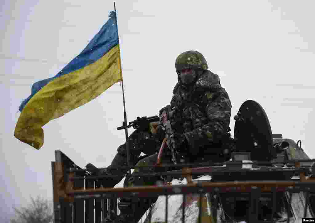 Members of the Ukrainian armed forces ride on a military vehicle near Debaltseve, eastern Ukraine, Feb. 16, 2015.