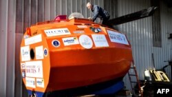 Jean-Jacques Savin, a former paratrooper, 71, works on the construction of a ship made from a barrel at the shipyard in Ares, southwestern France, Nov. 15, 2018. He is several days into his attempt to cross the Atlantic in a specially-built orange barrel, Dec. 31, 2018.