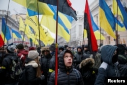 FILE - People attend a rally calling for Ukrainian lawmakers to recognize Russia as an aggressor state and support other anti-Russian legislative changes, near the Parliament building in Kyiv, Ukraine, Jan. 16, 2018.