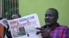 FILE - A man reads a copy of the Juba Monitor, Aug. 21, 2015 in Juba, South Sudan. The paper is still in operation but is not thriving.