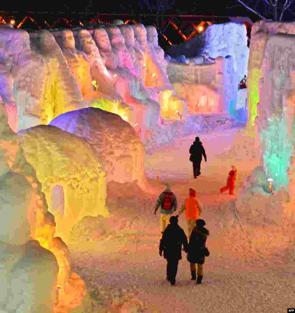 People visit the Chitose-Lake Shikotsu Ice Festival illuminated by colorful light to produce a fantastic world in Chitose, Japan, Jan. 24, 2014. 