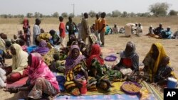 FILE - People displaced by Boko Haram wait to be screened at Furore camp in Yola, Nigeria, near the country's border with Cameroon, Dec. 8, 2015. Returnees to Cameroon have have been rejected by their communities. 