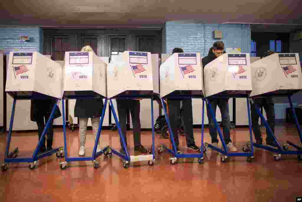 Voters fill out their forms at a polling station in the Brooklyn borough of New York, Nov. 8, 2016. 