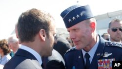 FILE - In this June 19, 2017 file photo, French President Emmanuel Macron, meets with Gen. Tod Wolters in Paris. At ceremonies Thursday in Germany and Friday in Belgium, Wolters will take over head of U.S. European Command and as NATO’s Supreme Allied Com
